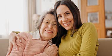 happy woman sitting with her mom who influenced her hobbies