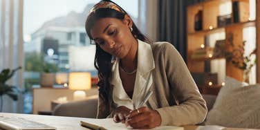 woman writing in commonplace book