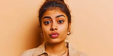 Young woman is intimidated but trying to hide it