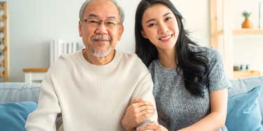 happy woman sitting next to her older father