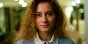 smiling woman who had a hard time in school now with enviable traits as an adult