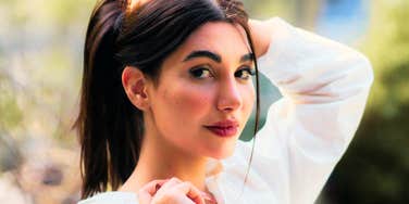 Natural light portrait of a woman outdoors with a calm expression