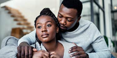 man touching wife's shoulders but making her feel unloved