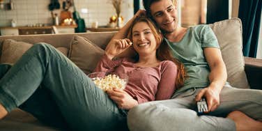 couple watching movie on couch