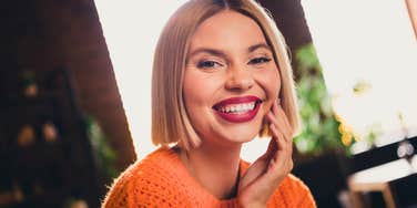 very gifted woman smiling and thinking