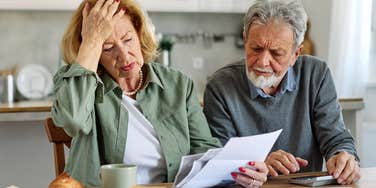 grieving parents looking over life insurance policy