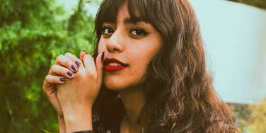 Confident woman looking directly at the camera with calm, self-assured expression