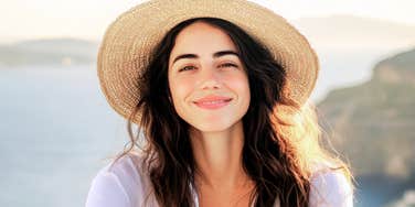 Woman resting her chin on her hand with a calm, self-assured expression, reflecting confidence and boundaries rooted in self-respect