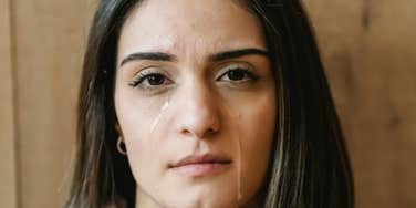 Woman tears up watching a movie.