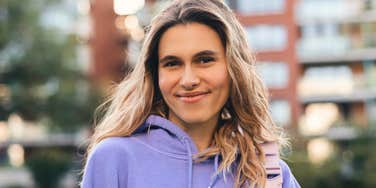 woman being annoying for no reason smiling slyly