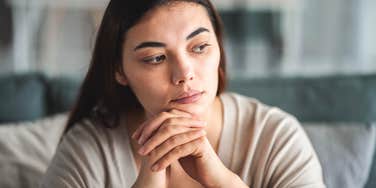 woman feeling overwhelmed by life sitting at home