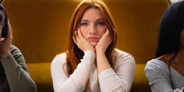 woman who never fit in feeling alone sitting next to two acquaintances