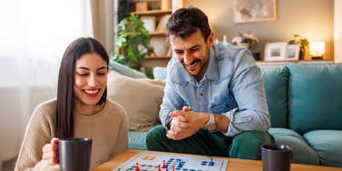 couple playing board game at home
