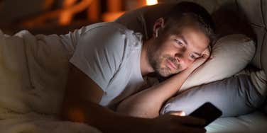 man staying awake at night on phone