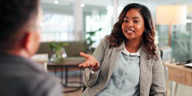 business woman talking to colleague at office