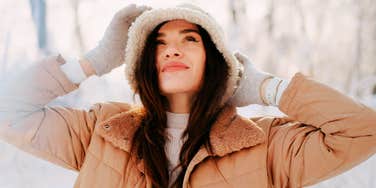 Woman smiling outside during the winter.