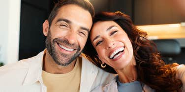 happy couple smiling together through stressful times