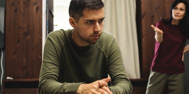 You Can Spot A Man Who Was Raised By An Overbearing Mom By These Pretty Obvious Behaviors annoyed grown man being yelled at by overbearing mom