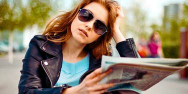 Gen Z woman reads a newsletter as a sweet tradition