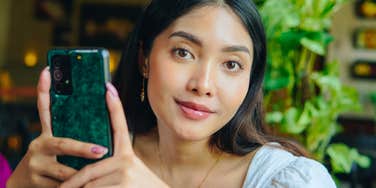 manipulative woman thinking of a text to send