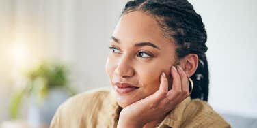 woman thinking with hand on her face