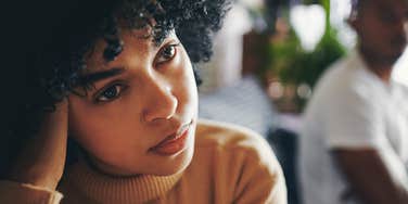 extremely unhappy wife sitting at home upset next to husband