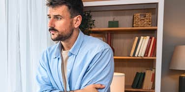 man standing alone in his home while his life collapses
