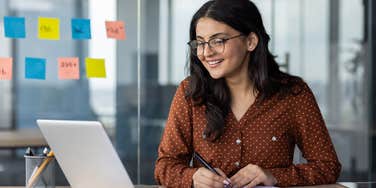 woman who is happy at work because she's been given unlimited sick days