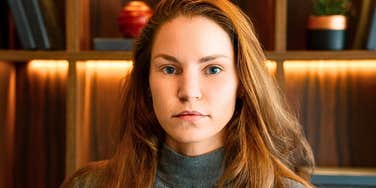 Genuinely classy woman looking serious in a library