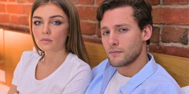 couple sitting up in bed together going through problems