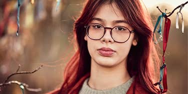 Young person with high IQ and low self-esteem outdoors 