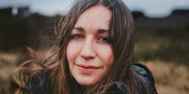 woman outdoors with wind-blown hair, reflecting on her choice to marry the wrong man and the reasons she’d do it again