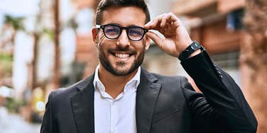 A man with true emotional intelligence adjusting his glasses