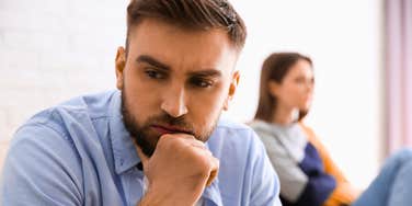 man quietly falling out of love turned away from his partner