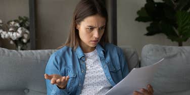 woman confused reading job rejection letter