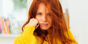 woman with a low iq lounging at home looking confused