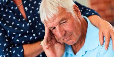 silent man hiding his stress being comforted by partner