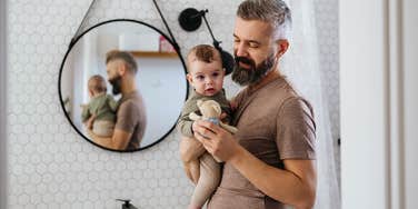 dad holding newborn baby
