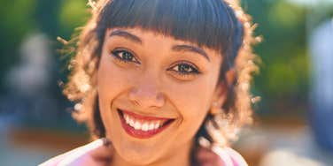 happy smiling woman with personality traits that are rare today