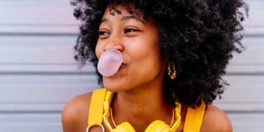 highly intelligent woman smiling and chewing gum