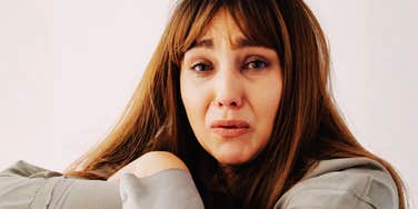A woman with long brown hair looking directly at the camera.
