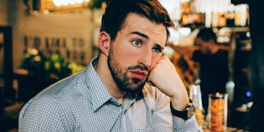 man not paying attention in conversation with friend