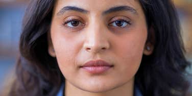 serious woman pretending to like people looking standoffish