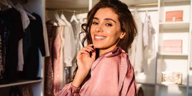 woman picking out the same type of outfit in her closet each morning