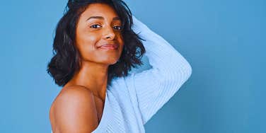 Woman who follows ancient body oiling tradition smiling and glowing