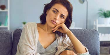 serious loner woman sitting at home alone