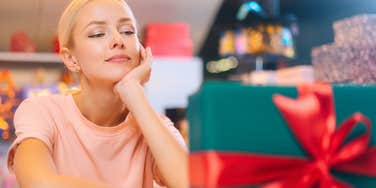 woman who hates opening gifts in front of others staring at present