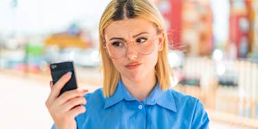 woman looking at her phone not answering the call