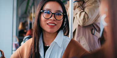 drama free woman talking to acquaintance on the bus