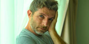 lonely adult man sitting at home alone not having friends